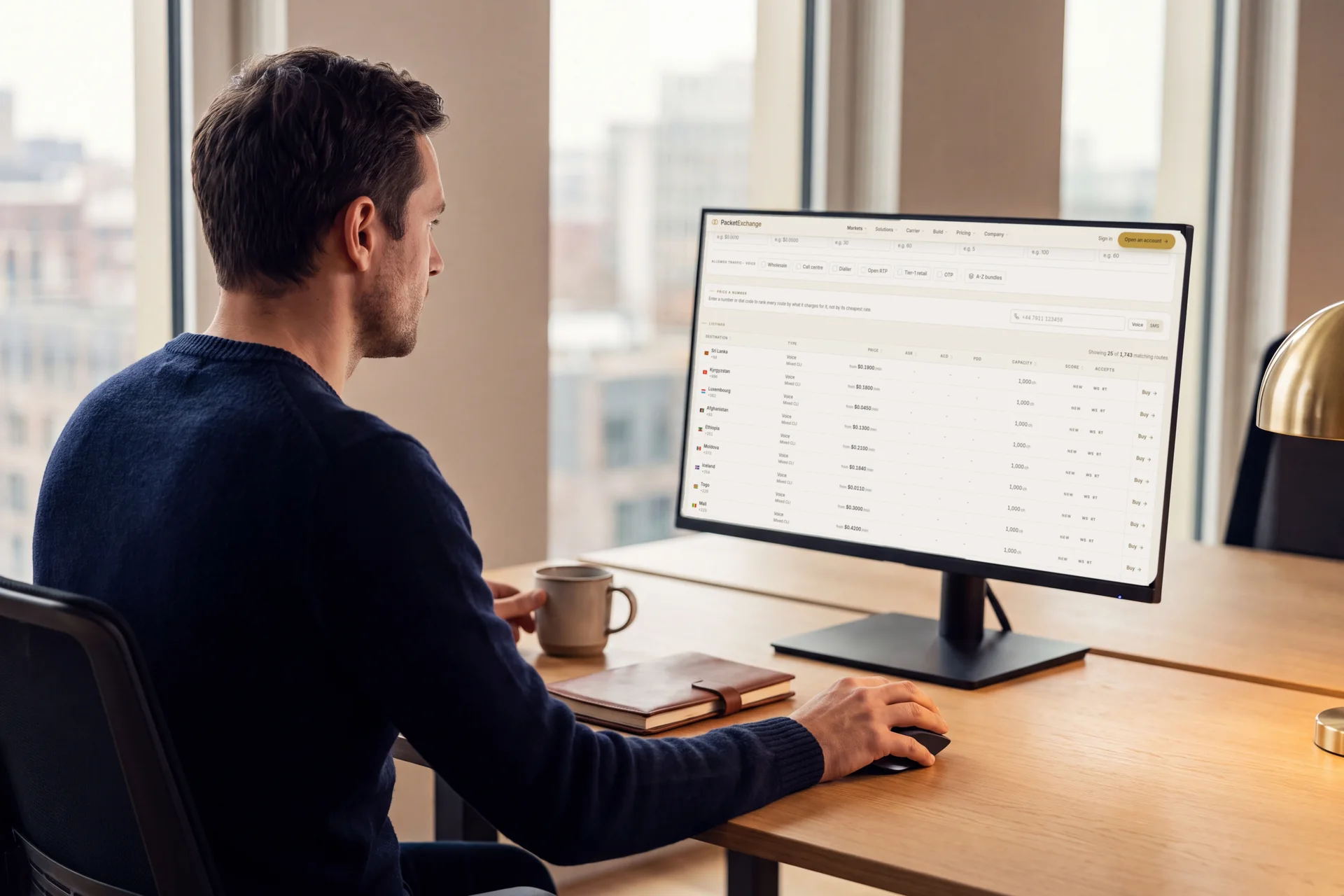 A wholesale voice buyer at his desk comparing route rates on the PacketExchange marketplace